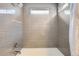 Shower and bathtub combo with gray tile at 12460 S Hollow Creek Ct, Parker, CO 80134