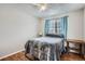 Cozy bedroom with wood floors, ceiling fan, and window coverings at 12460 S Hollow Creek Ct, Parker, CO 80134