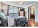 Main bedroom with en-suite bathroom and hardwood floors at 12460 S Hollow Creek Ct, Parker, CO 80134