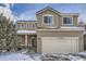 Two-story house with beige siding, attached garage, and landscaping at 12460 S Hollow Creek Ct, Parker, CO 80134