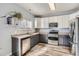 Kitchen with stainless steel appliances and two-toned cabinets at 12460 S Hollow Creek Ct, Parker, CO 80134