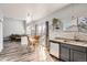 Bright kitchen features a breakfast nook, modern appliances, and wood-look floors at 12460 S Hollow Creek Ct, Parker, CO 80134