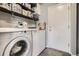 Laundry room with washer, dryer, and additional shelving at 12460 S Hollow Creek Ct, Parker, CO 80134