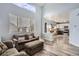 Open living room and kitchen with hardwood floor, and high ceiling at 12460 S Hollow Creek Ct, Parker, CO 80134