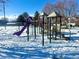 Winter playground scene with playset and slide at 12460 S Hollow Creek Ct, Parker, CO 80134