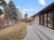 Expansive backyard featuring a white brick house and large patio at 3049 S Vine St, Denver, CO 80210
