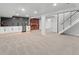 Spacious finished basement with built-in bar, wine storage, and staircase at 3049 S Vine St, Denver, CO 80210