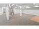 Finished basement with carpet, staircase and support pillars at 3049 S Vine St, Denver, CO 80210