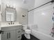 Bathroom features black hexagon tiles, a tiled shower and modern vanity at 3049 S Vine St, Denver, CO 80210