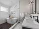 Modern bathroom features dual sinks, soaking tub, and walk-in glass shower at 3049 S Vine St, Denver, CO 80210