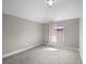 Neutral bedroom featuring plush carpeting, recessed lighting, and window at 3049 S Vine St, Denver, CO 80210