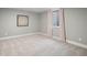 Cozy bedroom with soft carpet, a window with curtains, and modern wall decor at 3049 S Vine St, Denver, CO 80210
