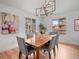 Bright dining room with hardwood floors, a modern chandelier, and bright views to the outside at 3049 S Vine St, Denver, CO 80210