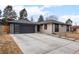 Charming single-story home featuring a modern garage door, inviting walkway, and updated exterior paint at 3049 S Vine St, Denver, CO 80210