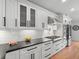 This kitchen is equipped with stainless steel appliances, custom cabinetry, and stone countertops at 3049 S Vine St, Denver, CO 80210