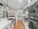 Modern kitchen features a stainless steel sink and appliances and a view into the dining room at 3049 S Vine St, Denver, CO 80210