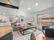 Bright living room with hardwood floors, open space, and access to dining and kitchen areas at 3049 S Vine St, Denver, CO 80210