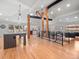 Bright living space with hardwood floors, wood beams, open floor plan, and modern lighting at 3049 S Vine St, Denver, CO 80210