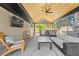 Covered outdoor patio with an outdoor kitchen, ceiling fan, and comfortable seating at 3049 S Vine St, Denver, CO 80210