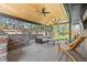Covered outdoor patio with an outdoor kitchen, ceiling fan, and comfortable seating at 3049 S Vine St, Denver, CO 80210