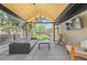 Covered outdoor patio with an outdoor kitchen, ceiling fan, and comfortable seating at 3049 S Vine St, Denver, CO 80210
