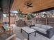 Covered outdoor patio with grill station, stylish seating, and manicured lawn at 3049 S Vine St, Denver, CO 80210