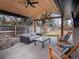 Covered outdoor patio with stylish seating area, ceiling fan, and tongue-and-groove ceiling at 3049 S Vine St, Denver, CO 80210