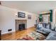 Living room featuring a brick fireplace and hardwood floors at 7845 W 9Th Ave, Lakewood, CO 80214