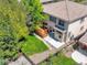 Aerial view of a home's backyard featuring a wooden deck, green grass, and gravel landscaping at 13895 Sandtrap Cir, Broomfield, CO 80023