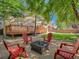 Backyard features a fire pit with Adirondack chairs, deck, and a fenced yard with lush landscaping at 13895 Sandtrap Cir, Broomfield, CO 80023
