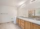 The bathroom features a double sink vanity, a large mirror, and a glass shower at 13895 Sandtrap Cir, Broomfield, CO 80023