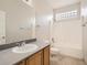 Well-lit bathroom features a shower-tub combo, tile flooring, and stylish vanity at 13895 Sandtrap Cir, Broomfield, CO 80023