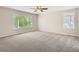 Large bedroom with plush carpet, a ceiling fan, and lots of natural light from the large window at 13895 Sandtrap Cir, Broomfield, CO 80023