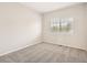 Bright bedroom featuring neutral carpeting, window with natural light, and crisp, clean finishes at 13895 Sandtrap Cir, Broomfield, CO 80023