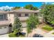 Charming two-story home featuring a well-maintained lawn, a two-car garage, and mature trees at 13895 Sandtrap Cir, Broomfield, CO 80023
