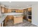 Modern kitchen with stainless steel appliances, wood cabinets, ample counter space, and wood floors at 13895 Sandtrap Cir, Broomfield, CO 80023