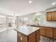 Bright kitchen features a center island, lots of cabinets, and an adjacent dining area with sliding door access to the back deck at 13895 Sandtrap Cir, Broomfield, CO 80023