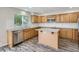 Well-lit kitchen featuring wood cabinets, stainless steel appliances, an island, and a window at 13895 Sandtrap Cir, Broomfield, CO 80023