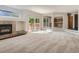 A spacious living room features a fireplace and sliding glass door access to the deck at 13895 Sandtrap Cir, Broomfield, CO 80023