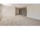 Spacious living room featuring neutral carpet and an open staircase to the upper level at 13895 Sandtrap Cir, Broomfield, CO 80023