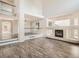 Open living room featuring wood floors, a fireplace, large windows, and high ceilings at 13895 Sandtrap Cir, Broomfield, CO 80023