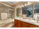 Main bathroom featuring a walk-in shower, dual sinks and lots of storage at 15491 E Wyoming Dr # A, Aurora, CO 80017