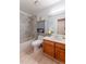 Bathroom featuring updated vanity, lighting, and shower with tiled walls at 15491 E Wyoming Dr # A, Aurora, CO 80017