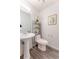 Half bathroom featuring a pedestal sink and updated fixtures at 15491 E Wyoming Dr # A, Aurora, CO 80017