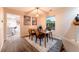 Dining room featuring modern furnishings, artwork, and a sunlit window with neighborhood views at 15491 E Wyoming Dr # A, Aurora, CO 80017