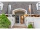 Townhome entrances featuring secure doors, decorative gates, and a covered entryway at 15491 E Wyoming Dr # A, Aurora, CO 80017
