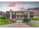 Inviting two-story townhome with balconies, a garage, stone accents, and lush landscaping at 15491 E Wyoming Dr # A, Aurora, CO 80017