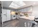 Bright kitchen featuring stainless steel appliances, light gray cabinets, and a skylight at 15491 E Wyoming Dr # A, Aurora, CO 80017