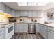 Updated kitchen featuring stainless steel appliances and light gray cabinets at 15491 E Wyoming Dr # A, Aurora, CO 80017