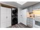 Kitchen featuring newer washer and dryer, stainless steel appliances and light gray cabinets at 15491 E Wyoming Dr # A, Aurora, CO 80017